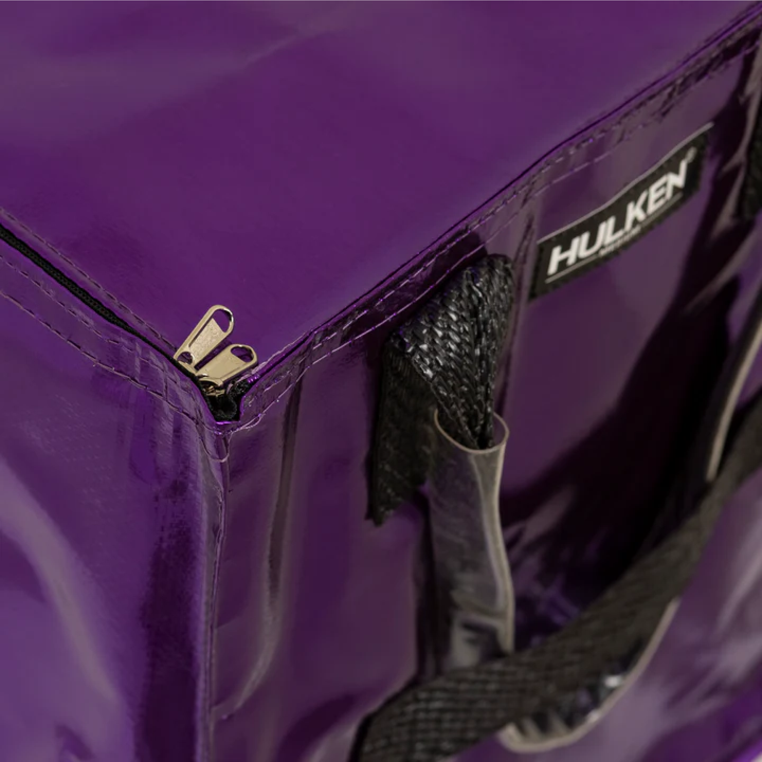 Detailed view of a purple tote bag's zipper closure