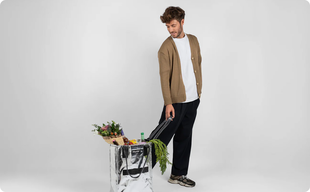 Person carrying a silver tote bag